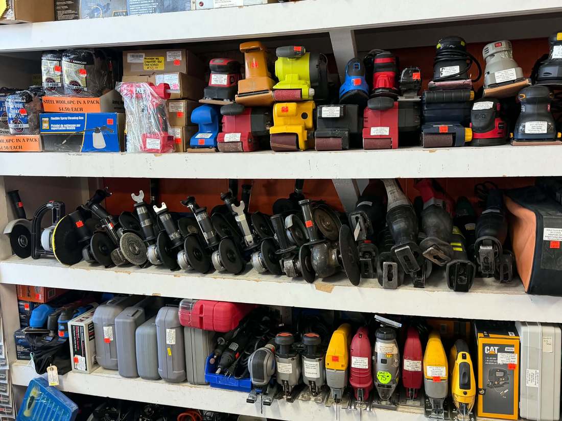 Shelves of used angle grinders, belt sanders, palm sanders and reciprocating saws at Deelz Tools and Such Calgary