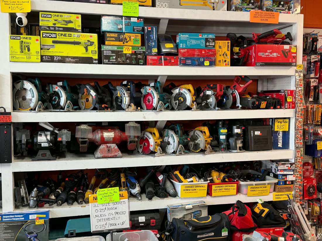 Rows of used circular saws, routers and trim saws under new-in-box tools at Deelz Tools and Such Calgary